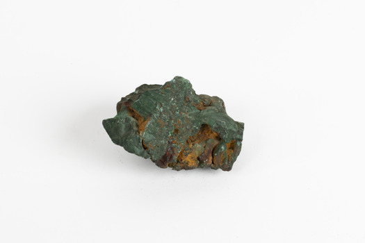 A hand-sized solid mineral specimen in shades of blue, green and copper.