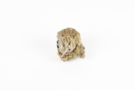 A small lead carbon specimen in shades of white, cream and brown. 