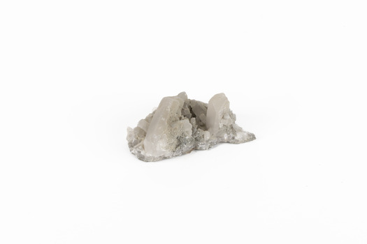 A small sized solid mineral specimen in shades cream and grey