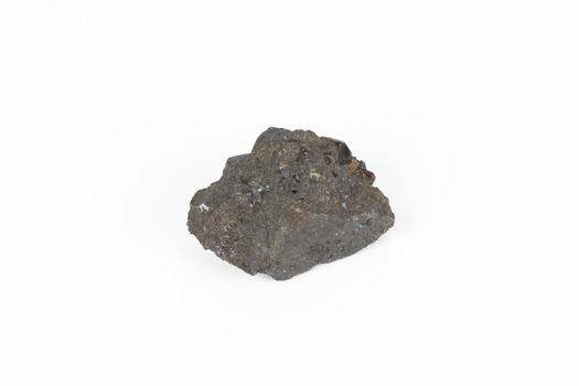 Coin-sized solid mineral in sades of black and red with black shiny points. 