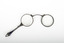 A pair of spectacles with a decorative handle attached.