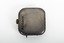 Small silver square with gold turner mechanism on left side of item. 