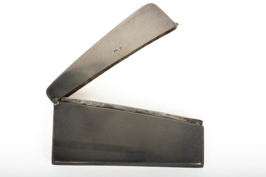 A small rectangular silver case for calling cards.