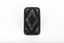 A small black rectangular box with a diamond design on top using small opal coloured flakes