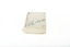 A small white rectangular box with cursive writing on top.