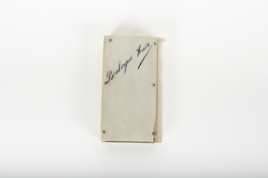 A small white rectangular box with cursive writing on top.