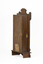 Rear side angle of wooden striking mantle clock showing shepherd's hook closure and an aged maker's label affixed to the back.