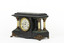 Angled obverse view of a Seth Thomas black mantle clock with green marbling detail. The clock face is white with black roman numerals and ornate gold rims. On either side of the clockface is a white pillar with bronze-coloured base and top. The clock also features ornate gold claw feet and fine gold painted detailing. 