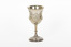 A silver trophy with an engraved flower design going around the cup. A seperate flower deign ring encircles the rim of the cup.