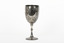Silver cup in the shape of a wine glass, as the cup tapers to a pedestal. The cup is engraved with branches and leaves, the base engraved with lines, dots and a half-moo pattern. 