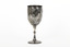 Silver cup in the shape of a wine glass, as the cup tapers to a pedestal. The cup is engraved with branches and leaves, the base engraved with lines, dots and a half-moo pattern. 