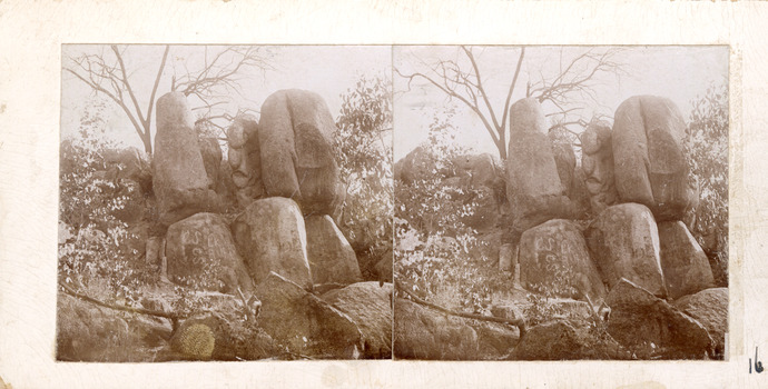 A stereoscopic photograph mounted on card depicting a cluster of large rounded granite boulders giving the appearance of a sphinx-like formation. 