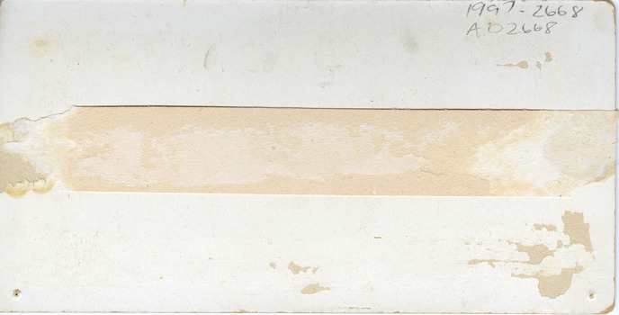 Stained and slightly torn card with pencil handwriting in the top right corner.