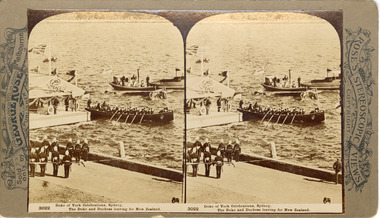 Two sepia toned photos of three boats on the water next to a floating dock/pontoon with land in the foreground. Two lines of officials stand on a road in the foreground, one boat in the centre of the image has a flag at each end, four oars visible and 15-17 people seated in it. The pontoon has a roof with official regalia including the British flag. The other boats in the background are smaller with only two people clearly visible.
