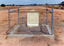 Desert grave stone of Dost Mahomet surrounded by singular pipe fence.