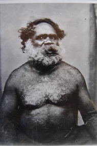 Upper body of mature bearded and tattooed Aboriginal man