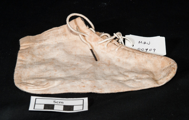 A calico infants bootee with laces