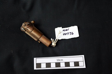 Manufactured objects, Cigarette lighter, brass cylinder, 20thC