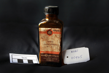 Manufactured Glass, brown bottle 'Saccharin', 20thC