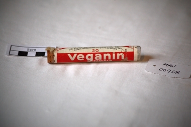 Containers, 'VEGANIN' plastic cylinder with rubber stopper, c1960
