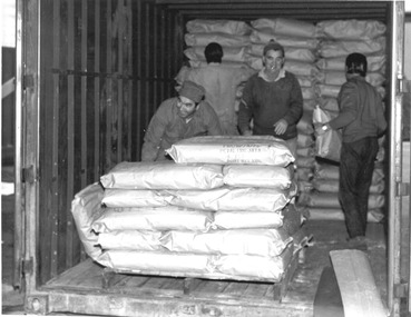 Photograph - Photograph - unloading bagged goods from back of truck, n.d