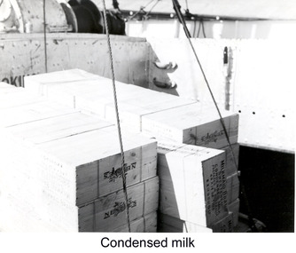 Photograph - Photograph - Milkmaid Brand Sweetened Condensed Milk in crates being lifted by crane, n.d