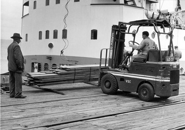 Photograph - Photograph - View of forklift loading timber planks on deck of a ship, 12/05/1976