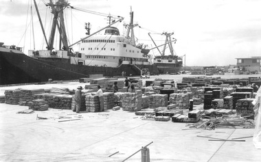 Photograph - Photograph - View of packaged timber products on dock in preparation for loading, n.d