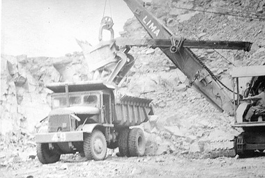 Photograph - Photograph - Shovel loading truck with rocks, c. 1962