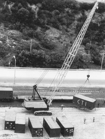 Photograph - Photograph - crane unloading containers from cargo train, 1980s