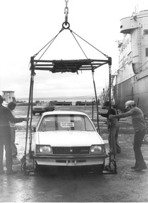 Photograph, Lifting Holden onto ship with crane for export, n.d
