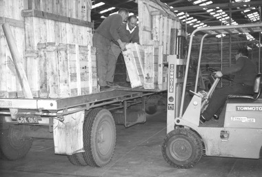 Photograph - Photograph - loading wooden cases from a truck, n.d