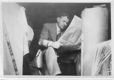 Photograph - Digital Image, Man reading paper at Greensborough Co-op, 1950c