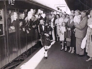 Photograph - Digital Image, David Vickers with bagpipes at train, 1950s