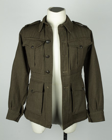 Green woolen long sleeved uniform jacket with metal buttons, belt and colour patch on sleeve