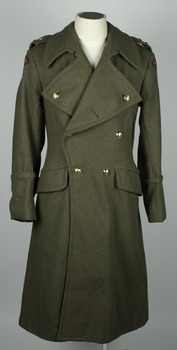 Double breasted Army Khaki coat with brass buttons on manequin with white background.