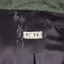 Sewn manufaturer's label at the inside nap of coat with purple lining. Rectangle, white label with black text reads: M.TX
