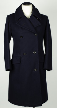 Double breasted navy blue coat with black buttons on a mannequin with white background.