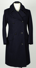 Double breasted navy blue coat with black buttons on a mannequin with white background.