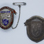 Silver enamel sheid shapped badge with red ribbon top and Australian Coat of Arms. Brass pressing proof of same badge. On white background