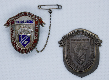 Silver enamel sheid shapped badge with red ribbon top and Australian Coat of Arms. Brass pressing proof of same badge. On white background