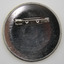 Back of circular badge with fastening pin - horizontal