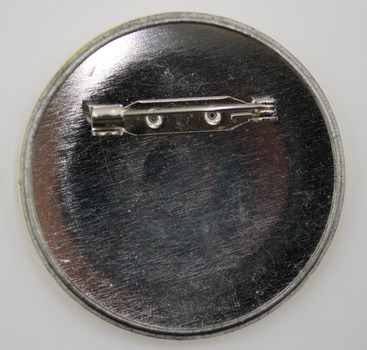 Back of circular badge with fastening pin - horizontal