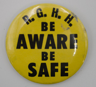 Round button badge, yellow background with black text