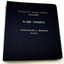Navy blue hard cover binder with gold embossed lettering. On white background