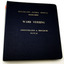 Navy blue hard cover binder with gold embossed lettering. On white background