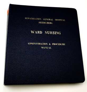 Navy blue hard cover binder with gold embossed lettering. On white background