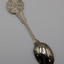 Back view of a teaspoon with round head and stem with embossed pattern