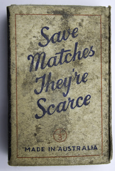 White matchbox with blue writing and red border.