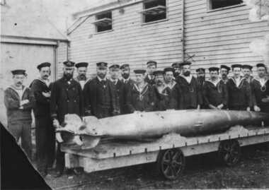 Photo of Men and 2 Torpedoes